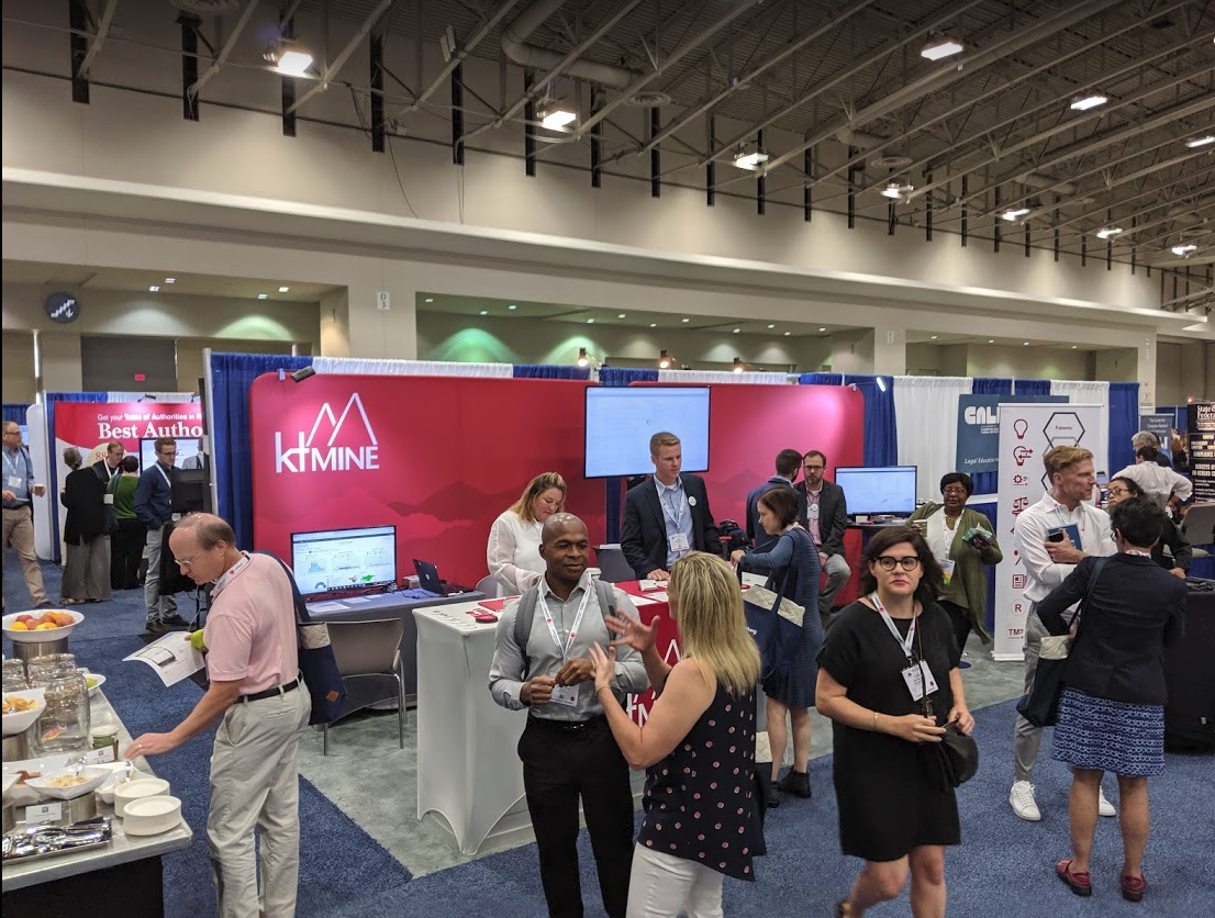 Attendees mingle around the ktMINE booth at the AALL Annual Meeting in 2019