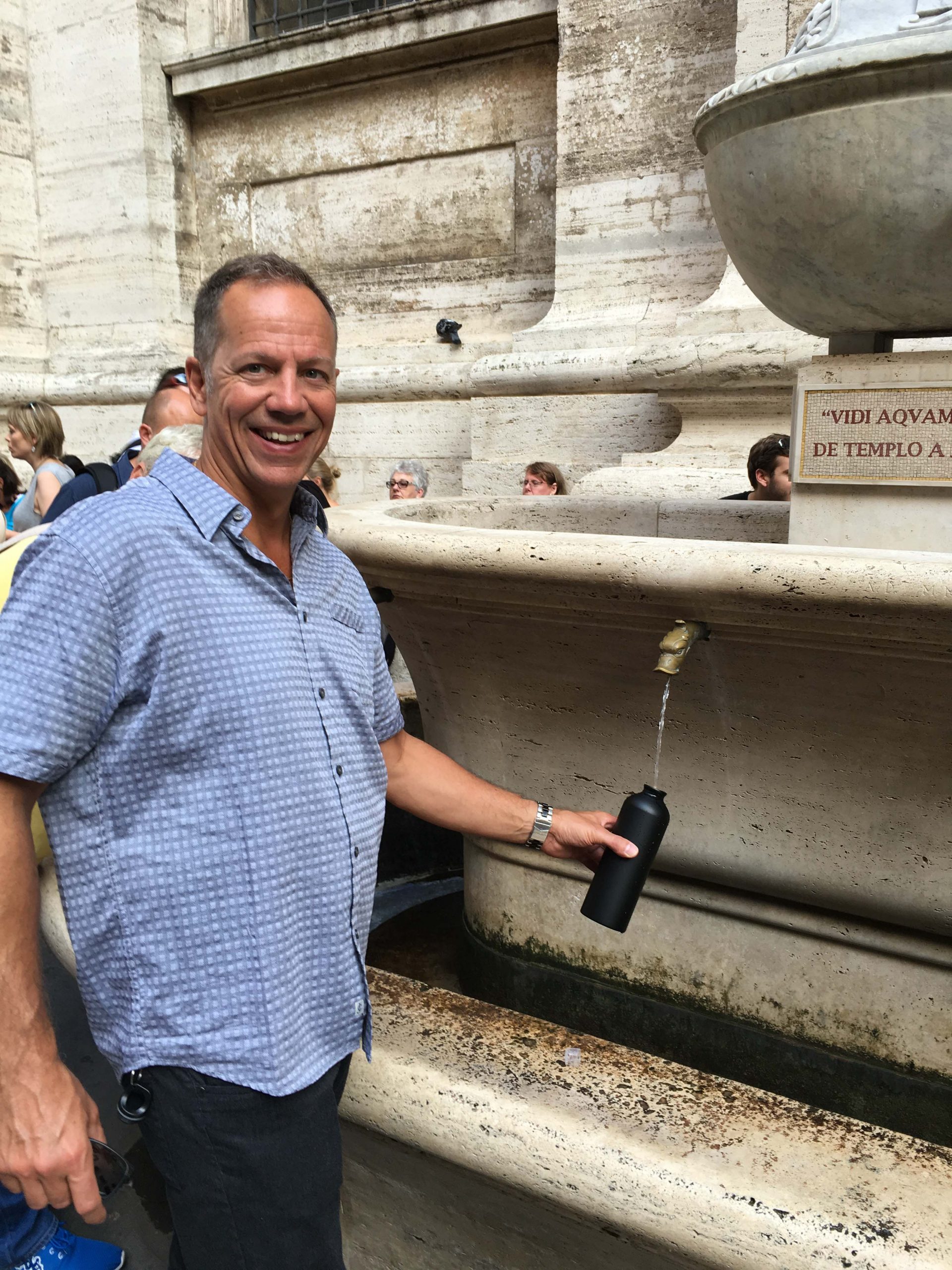 man filling up water in Italy