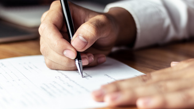 man signing a contract